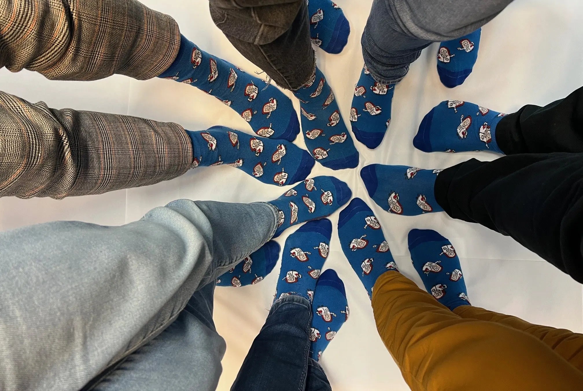 employee feet with trenzyme cellebrity socks in a circle